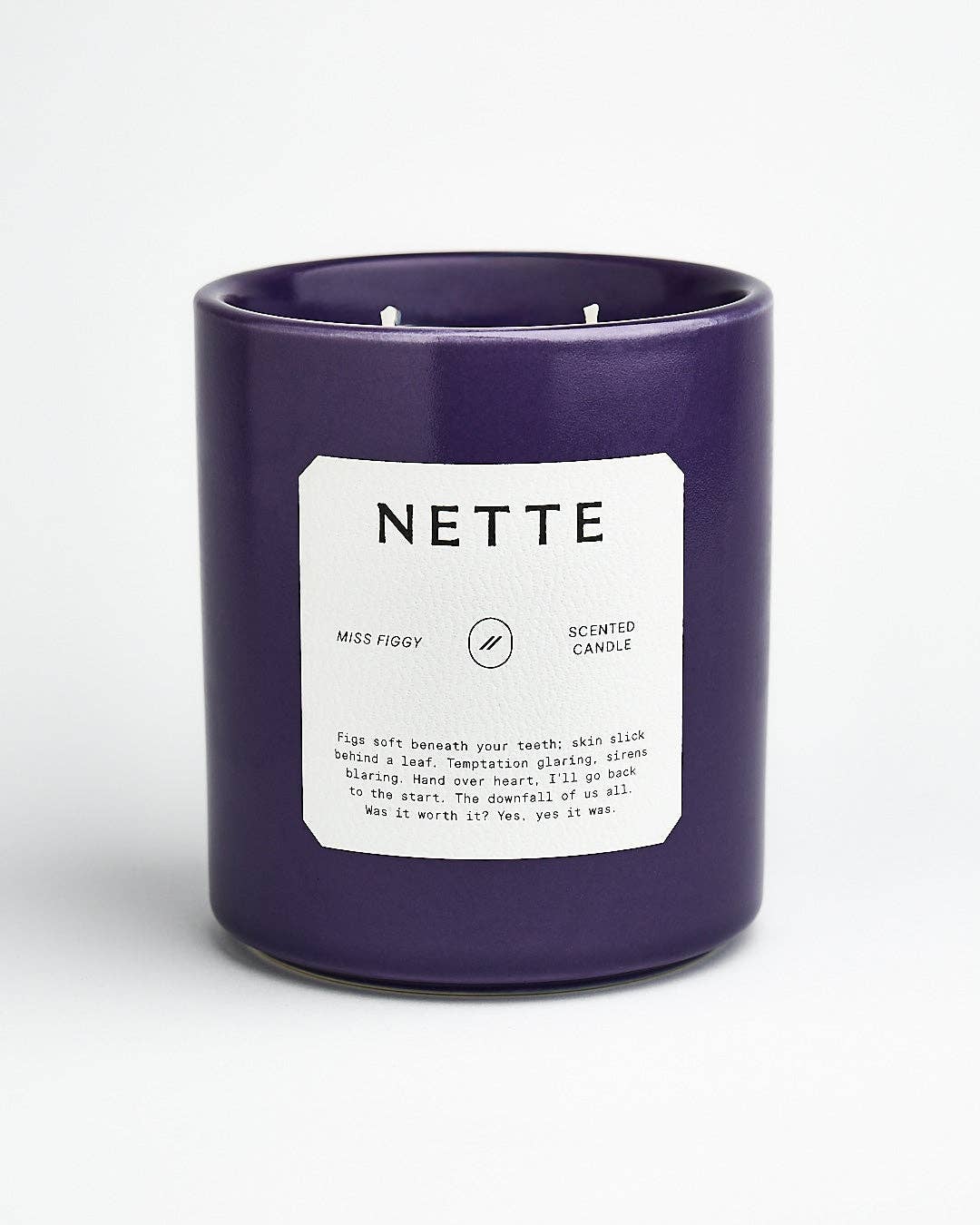 Miss Figgy candle in a deep purple ceramic jar with a white Nette label