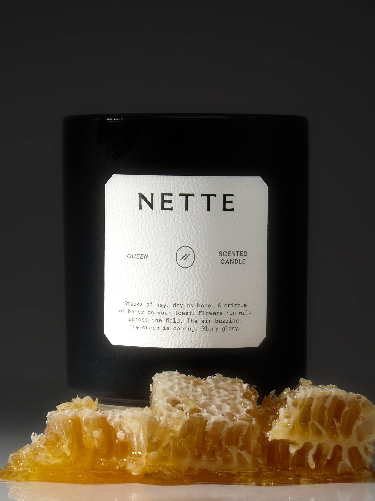 Queen candle sitting on a bed of honeycomb